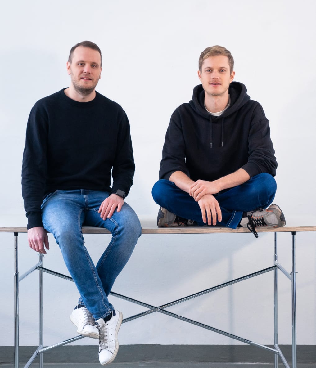 Two young men sitting on a table