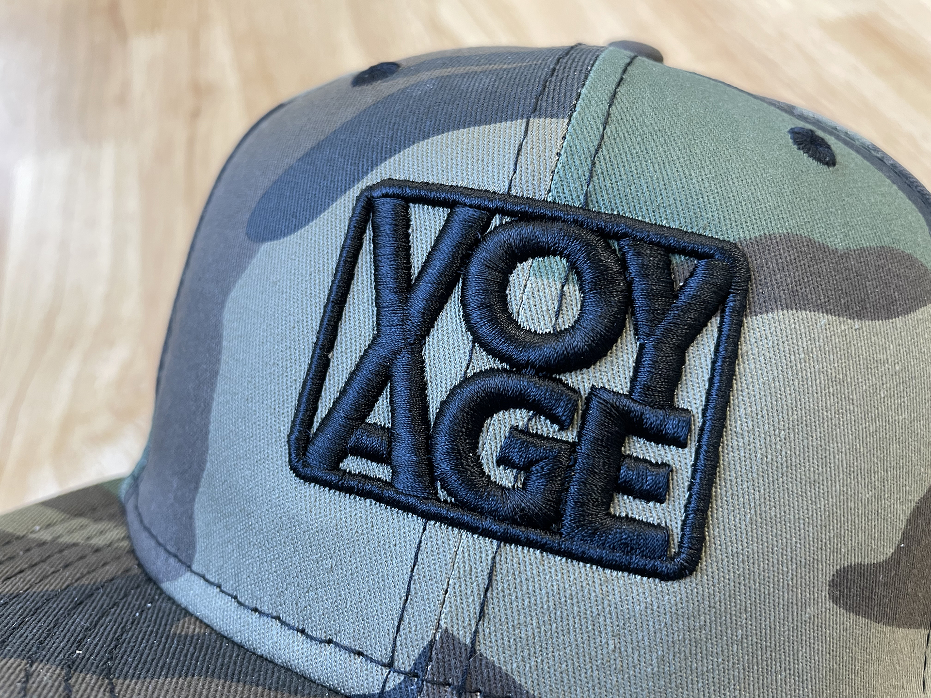 Up close shot of hat with voyage logo embroidered on it