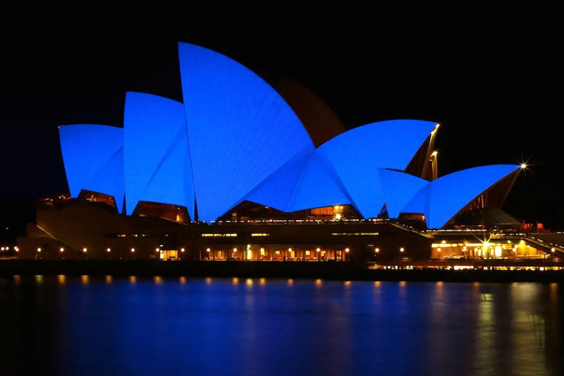 sydney harbour bridge at night lit up in blue for world autism day