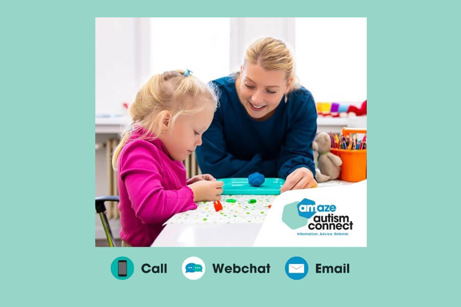 Young girl sitting a desk colouring with mum