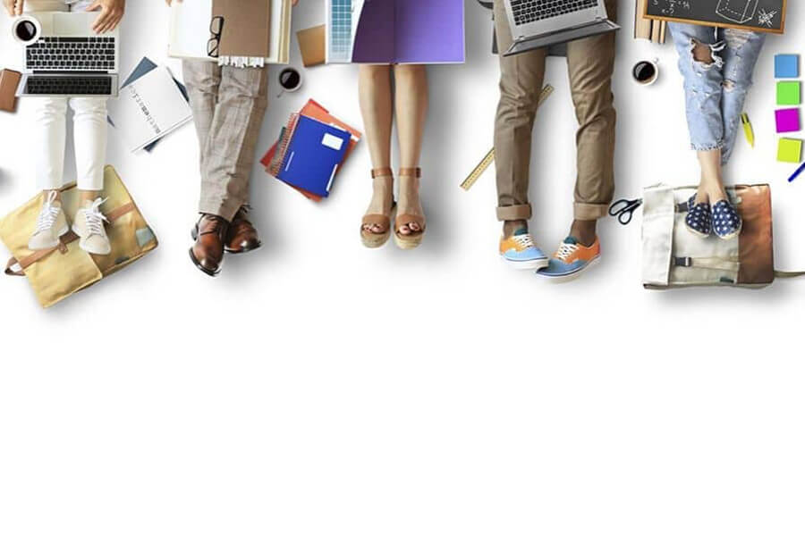Concept image of people sitting of the floor on laptops with coffees and books