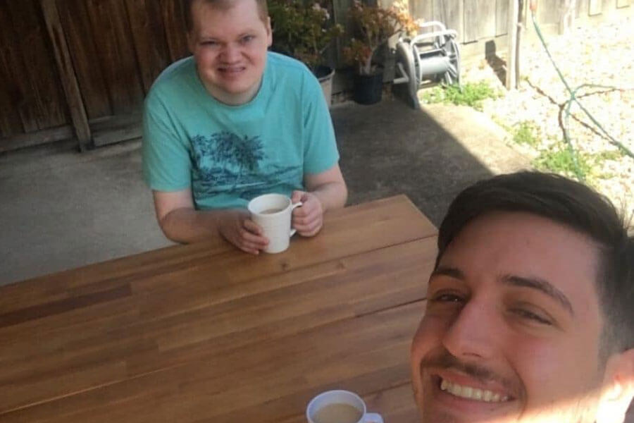 Selfie of two young adult men drinking coffee