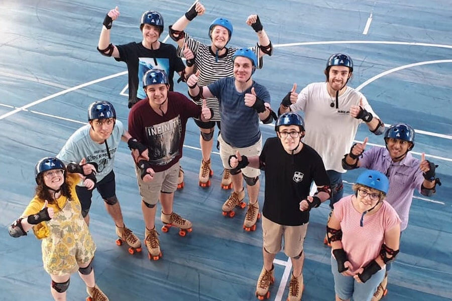 Group of people on roller skates giving thumbs up