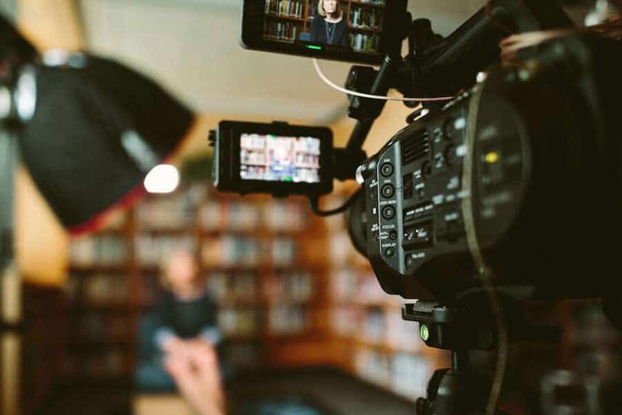 TV camera recording a woman speaking to the camera