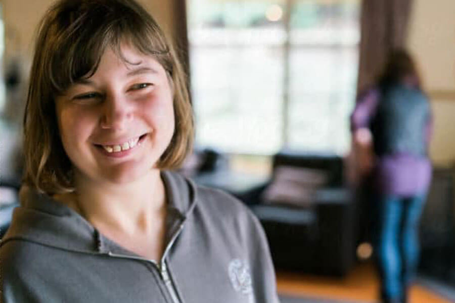 Teenager with autism smiling in a classroom