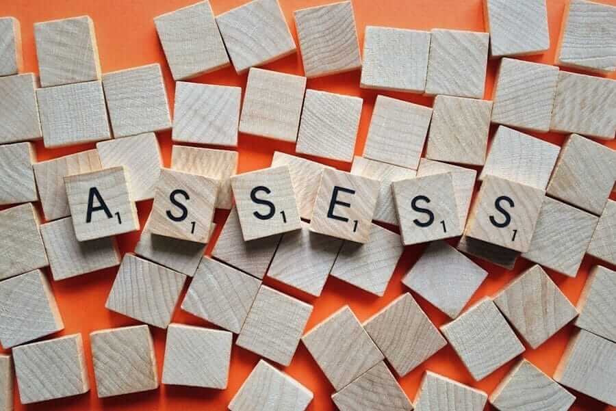 Scrabble pieces spelling out assess