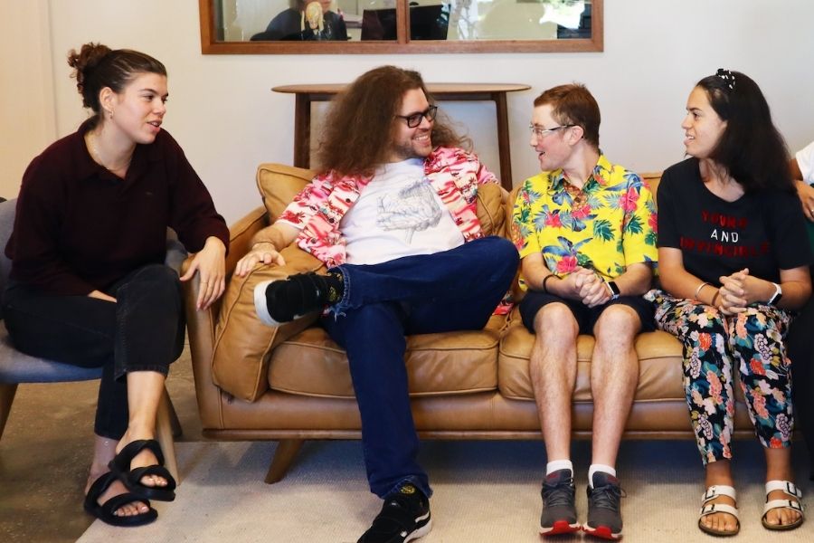 autistic adults socialising on a lounge