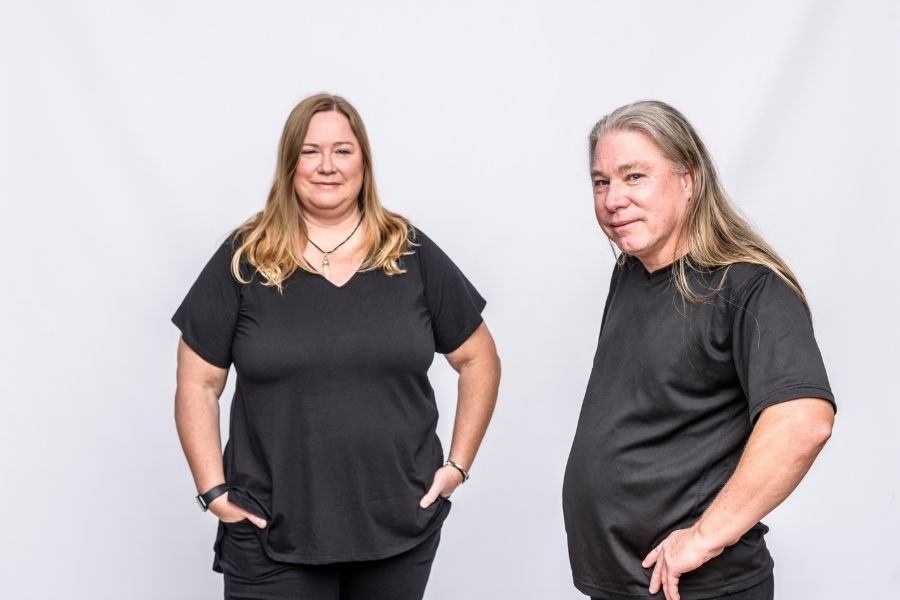 autistic woman and autistic man dressed in black with white background