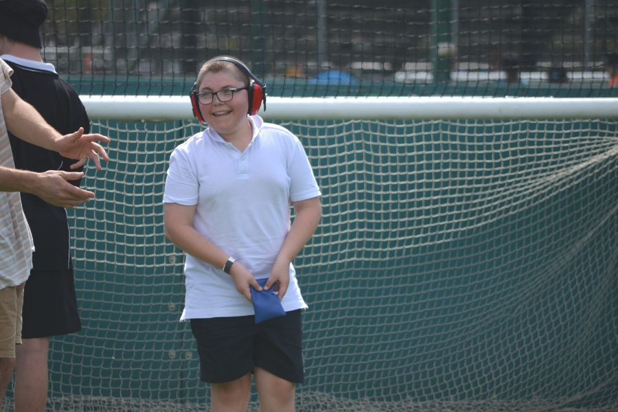 child smiling playing sport with noise cancelling headphones