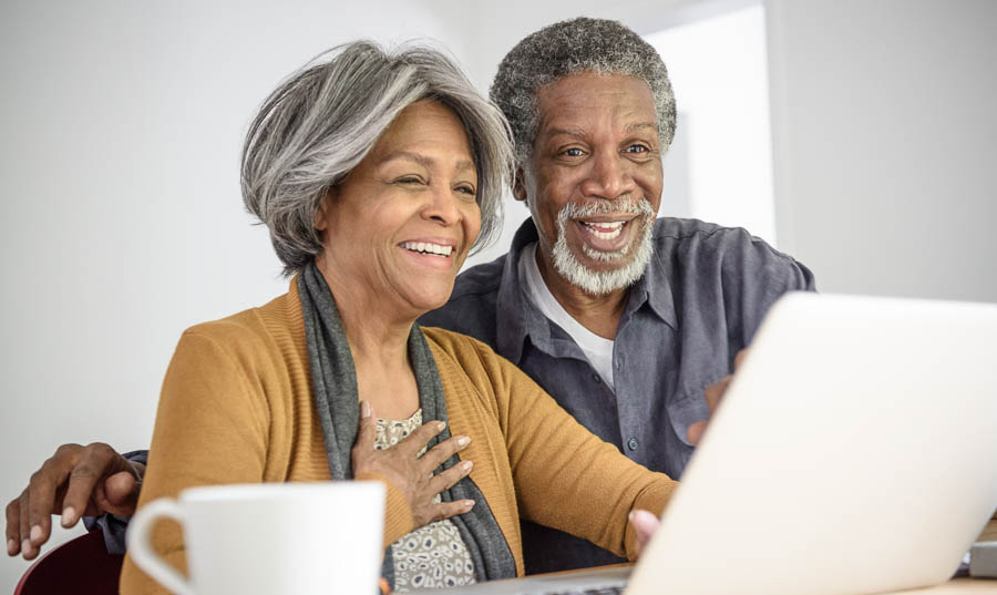 Happy African American seniors using computer
 