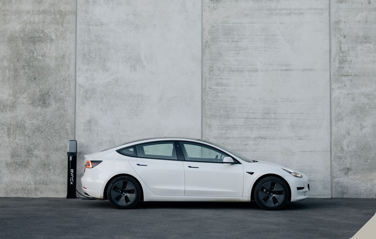 An Evnex smart EV charger with Tesla Model 3 car.