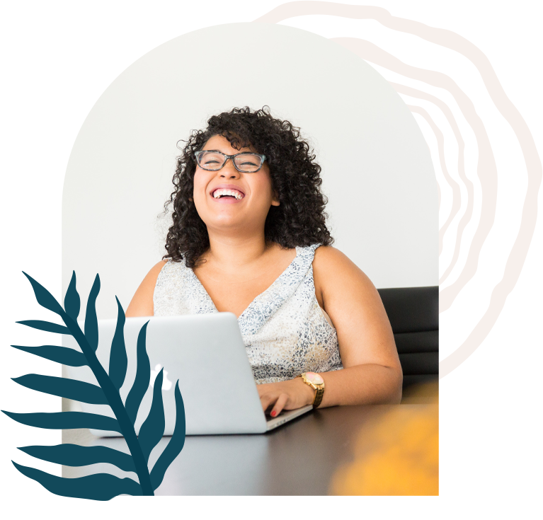 A person laughing while on a computer at a desk, with a fern leaf and tree trunk ring graphics in the background.