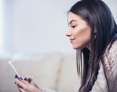 Lady smiles at her phone