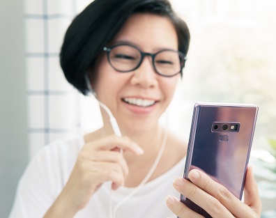 Asian lady looks at her phone