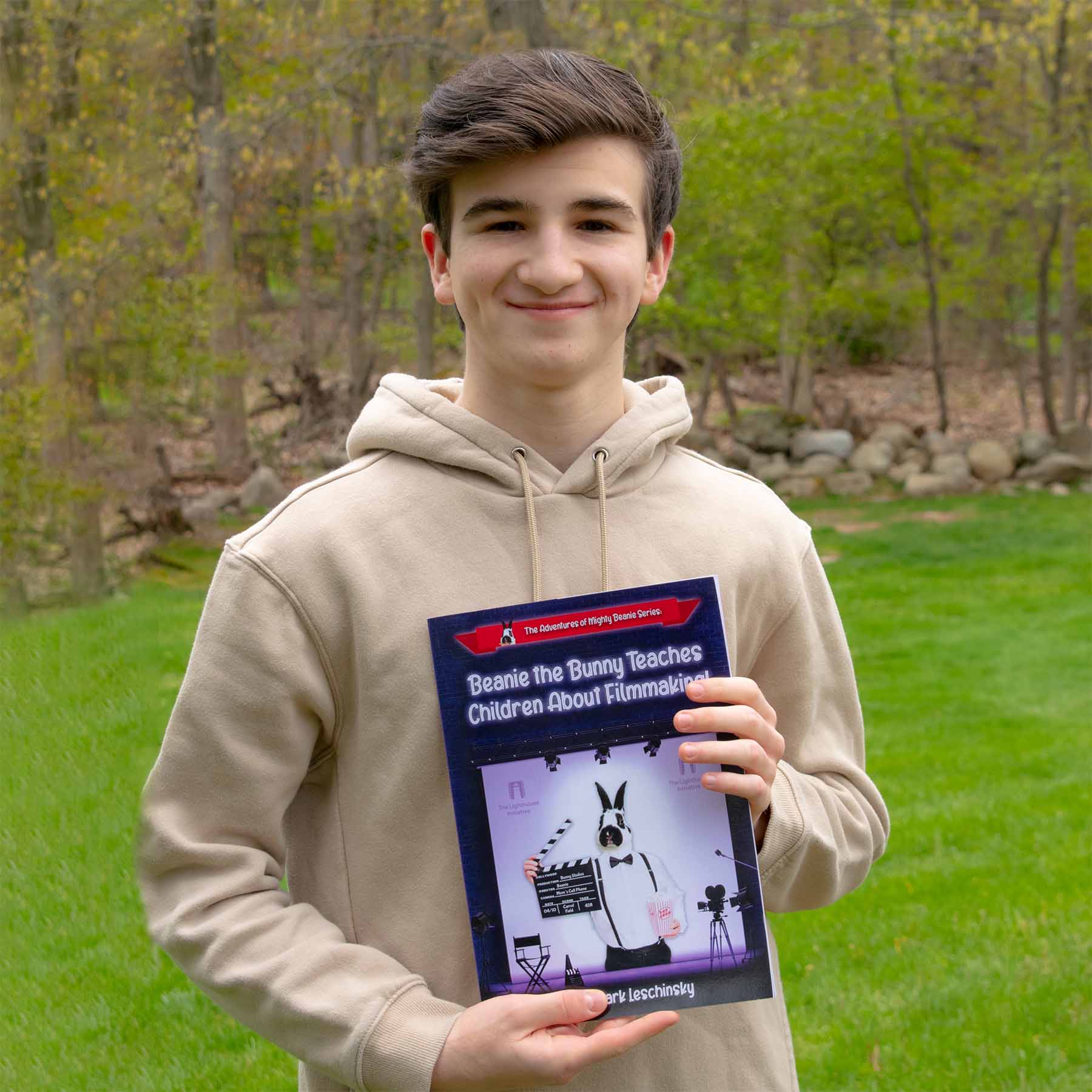 Mark Leschinsky holding his children's filmmaking book.