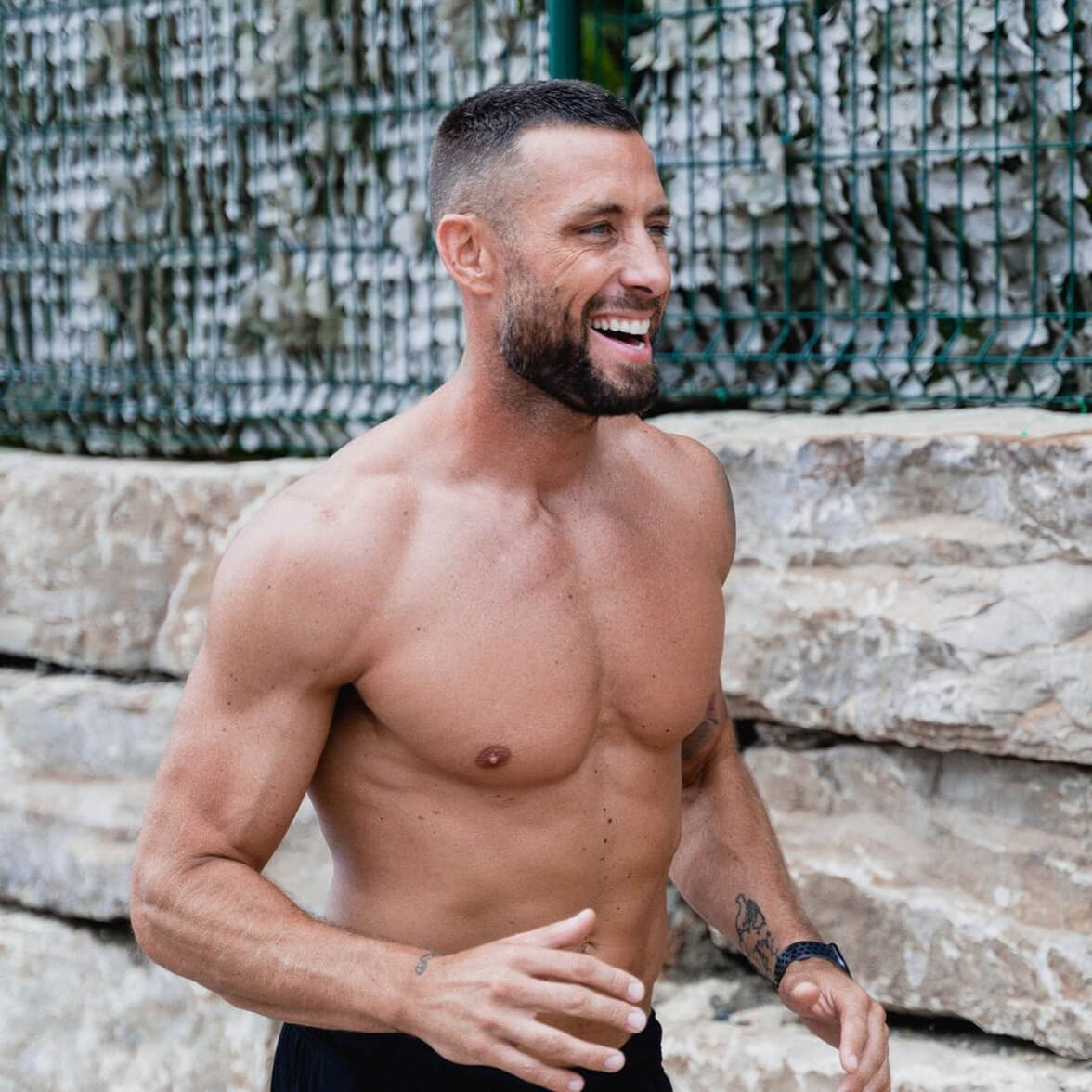 Mike without shirt smilling