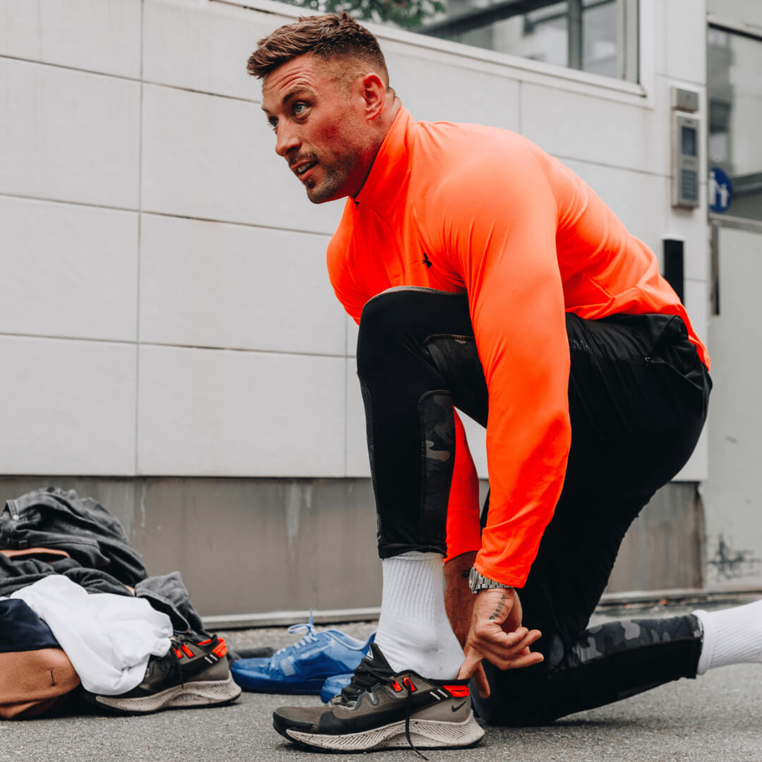 Picture of Mike putting his training shoes on