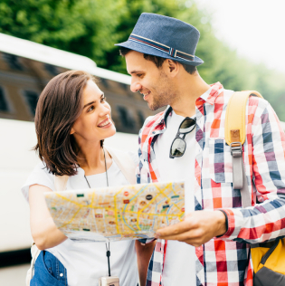 Young family tourists looking attentively in map