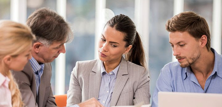 Four people discussing.