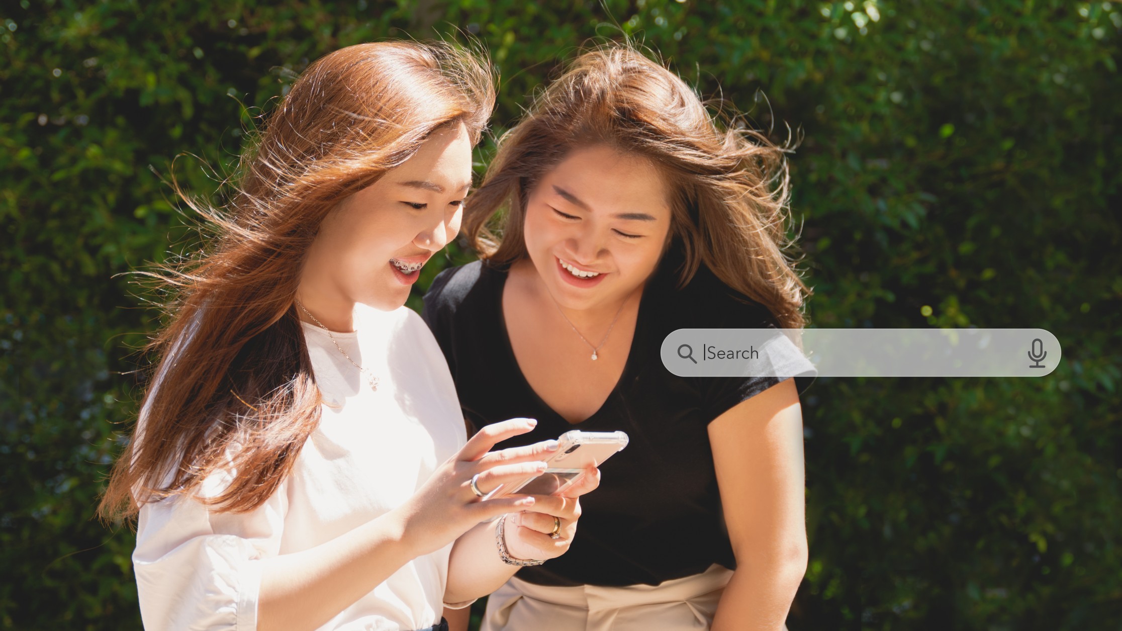girls using a smartphone for learning