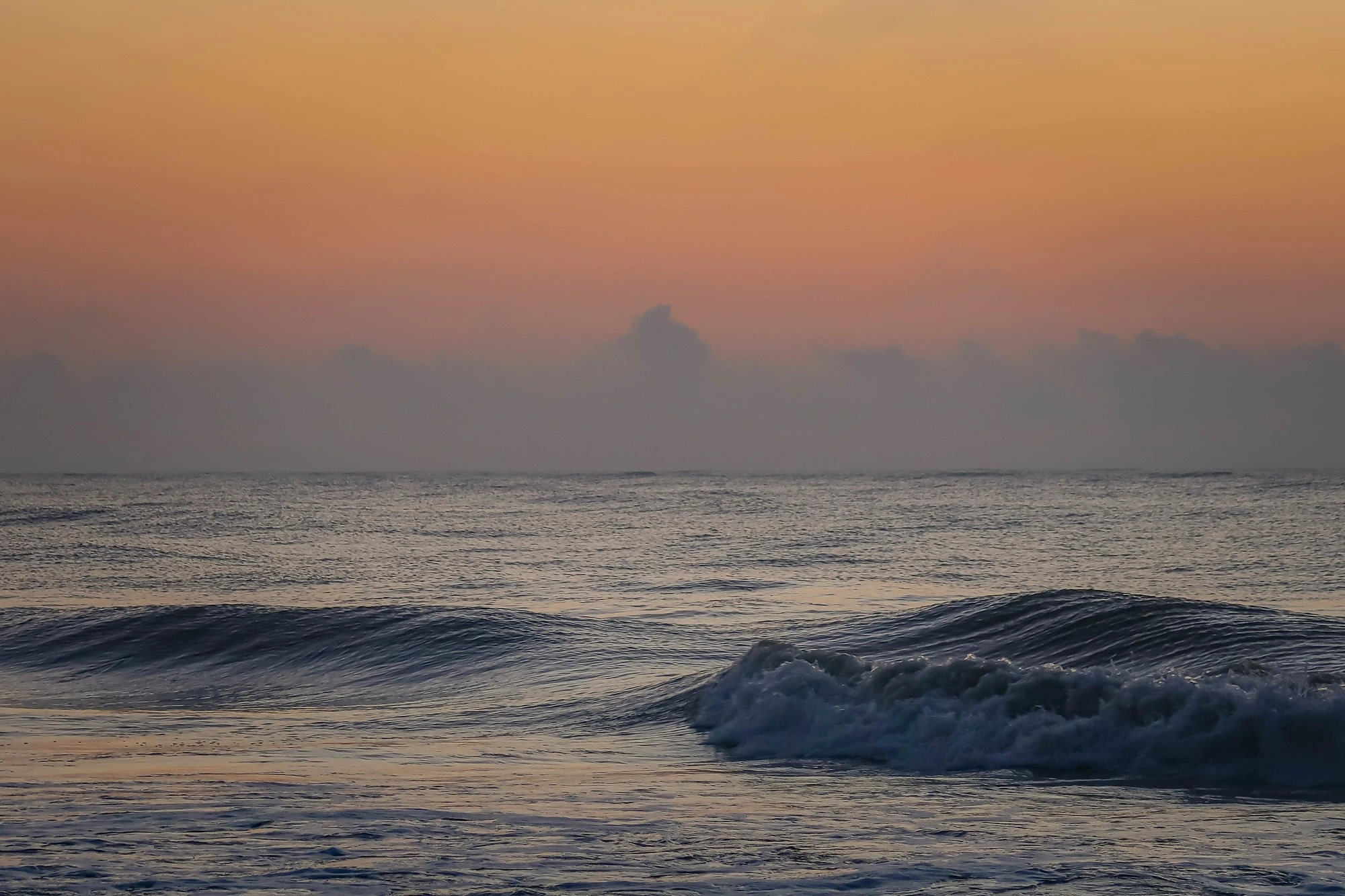 Golden Isles: wave crashing on the shore with a sherbet sky overhead