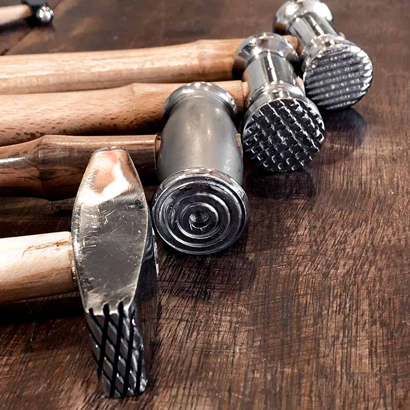 Jewellery making hammers on a wooden surface