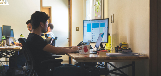 An employee of the company works on a PC