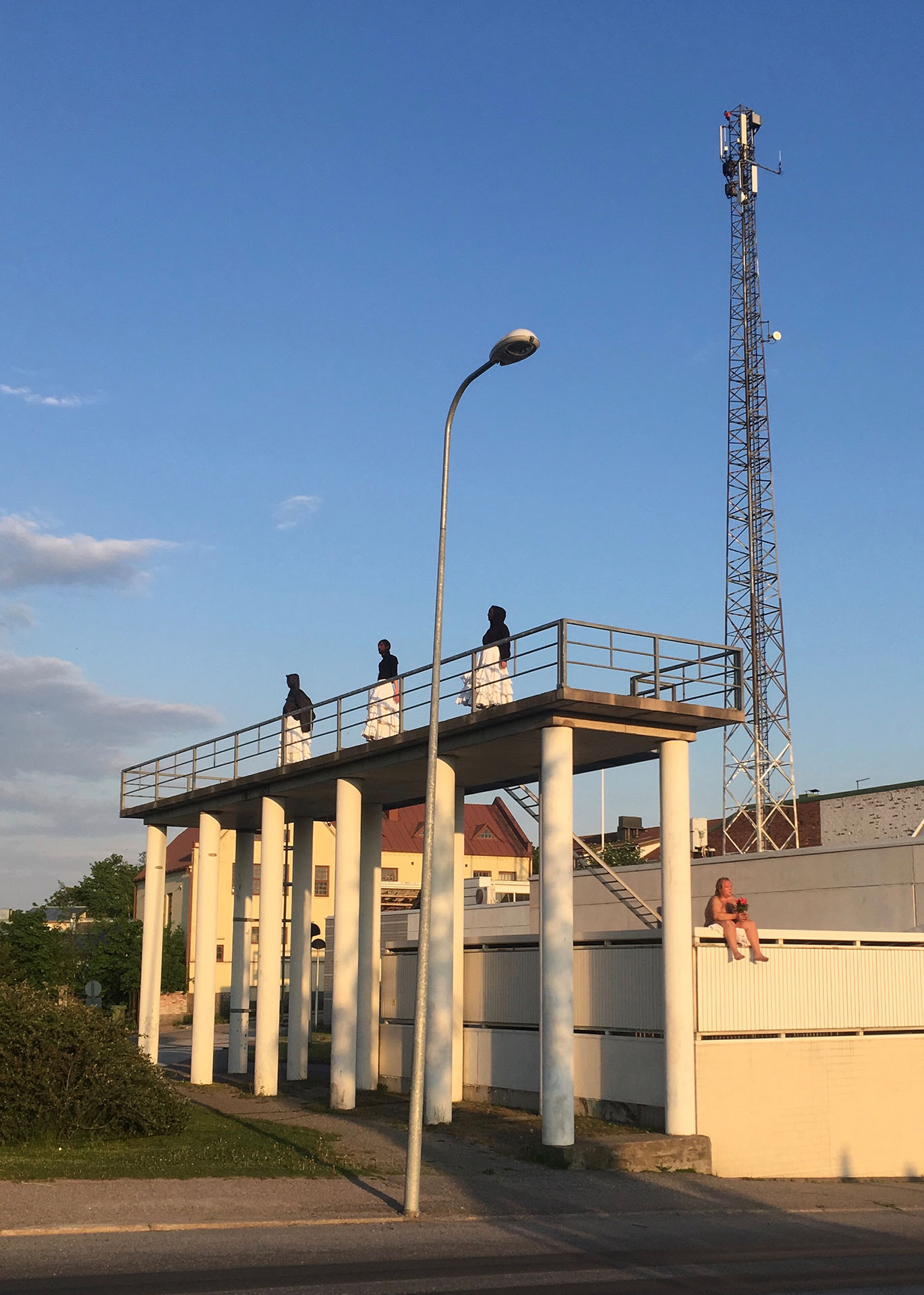 People standing on a bridge.