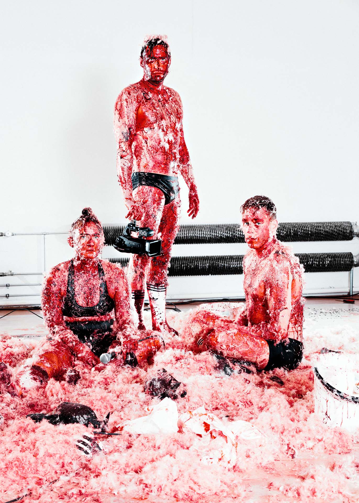Three persons on the floor with only underwear. 