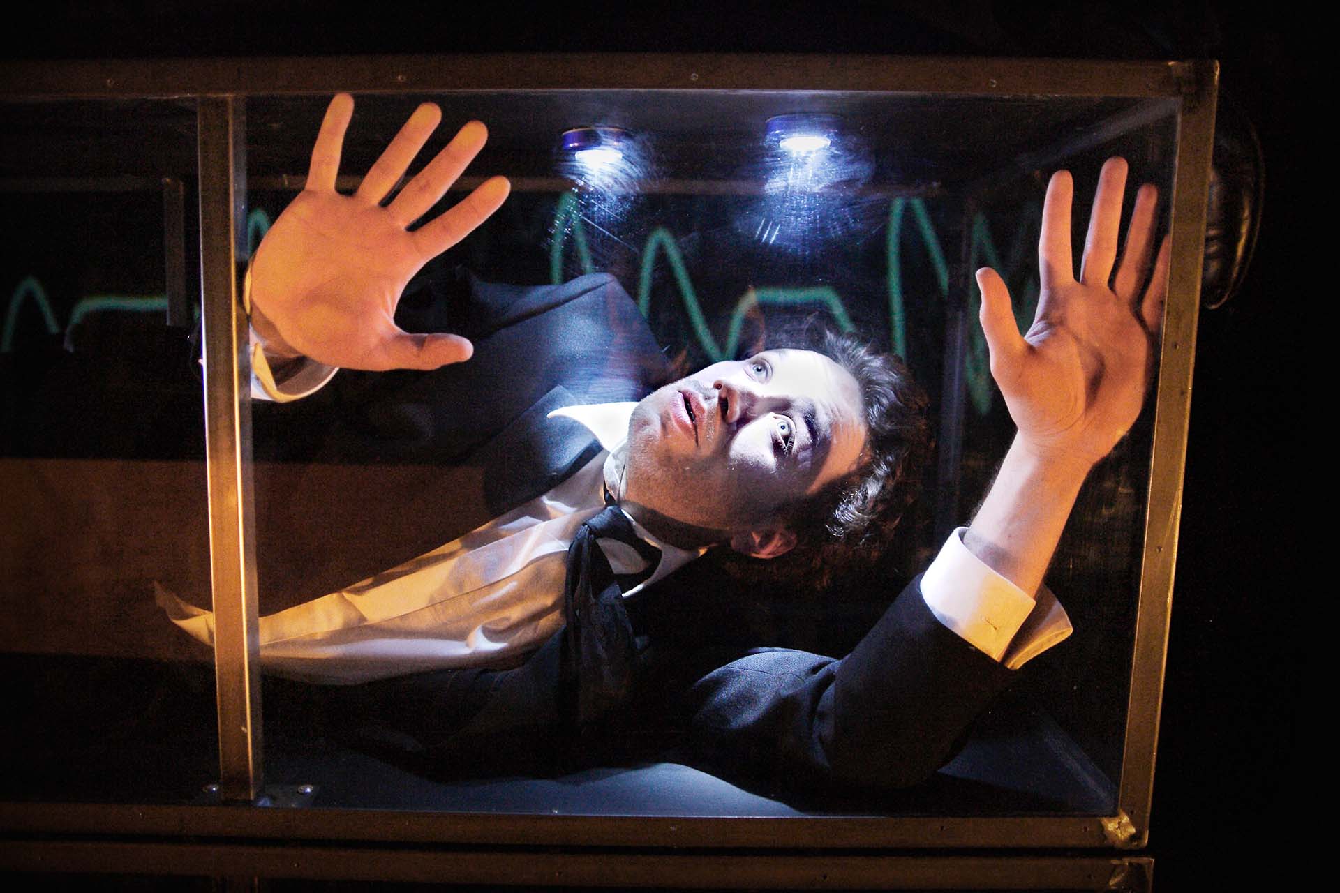 A man in a small box trying to get out