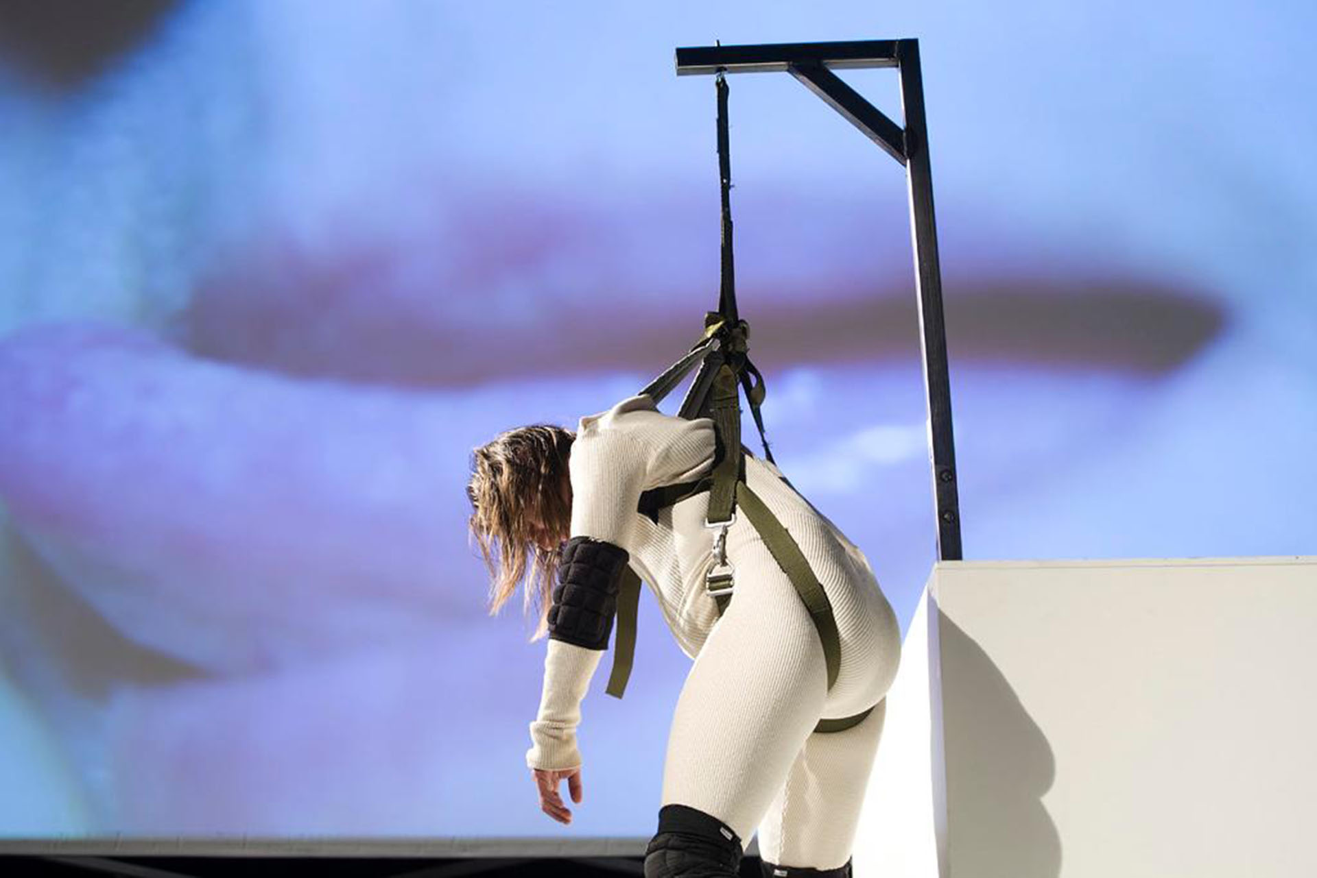 man hanging in a white overall