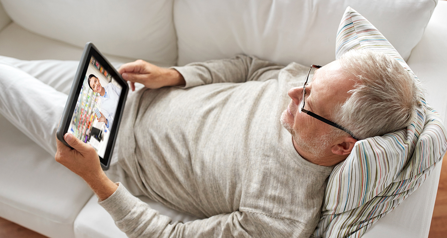 Man having video chat with pharmacist.