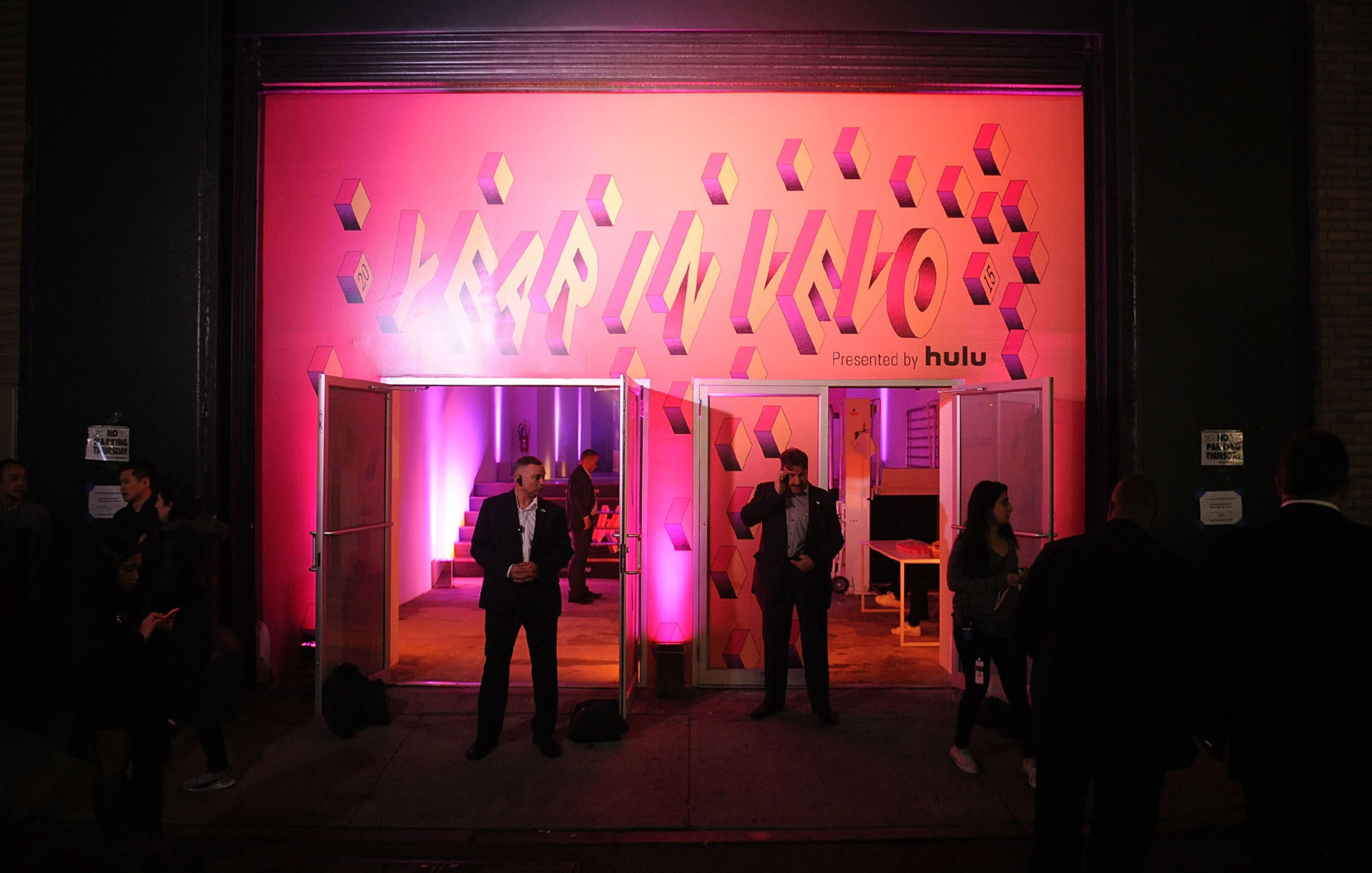 vevo in a year logo on top of the door with two security guards outside the door wearing suits