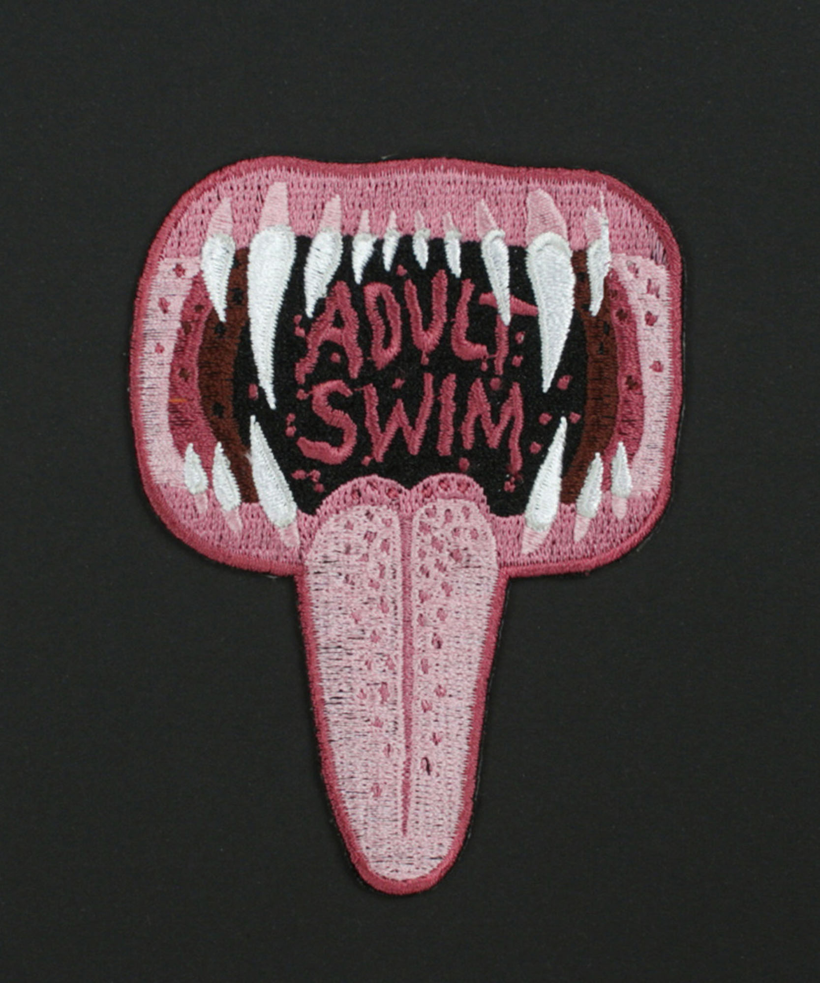 an illustrated mouth with sharp teeth with the words Adult swim and a tongue hanging out