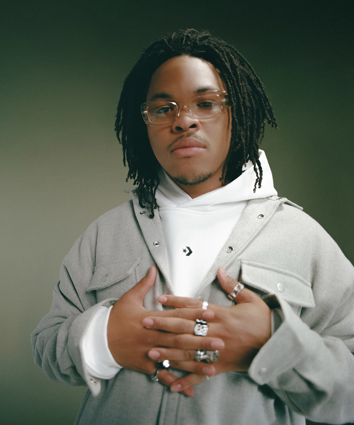 male model with his hand interlocked wearing a converse hoodie