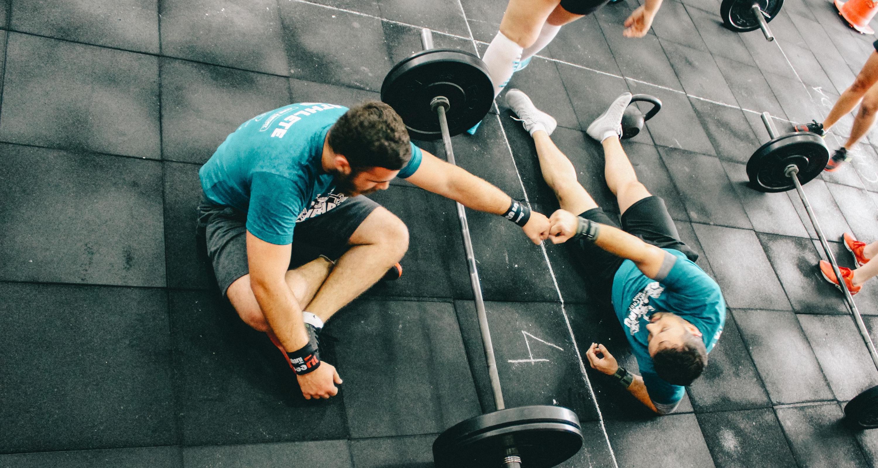two people with barbell