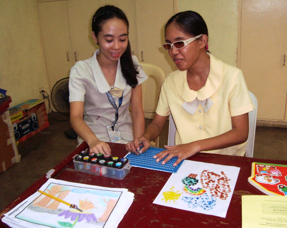 Cebu Braille Center Inc. - Two girls working on an activity.