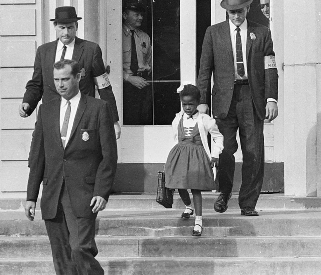 Young Ruby Bridges in 1960 accompanied by U.S. Marshals to attend an all-white school