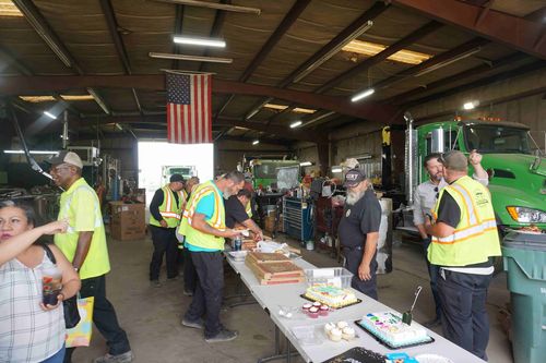 Employees celebrate an event with cupcakes