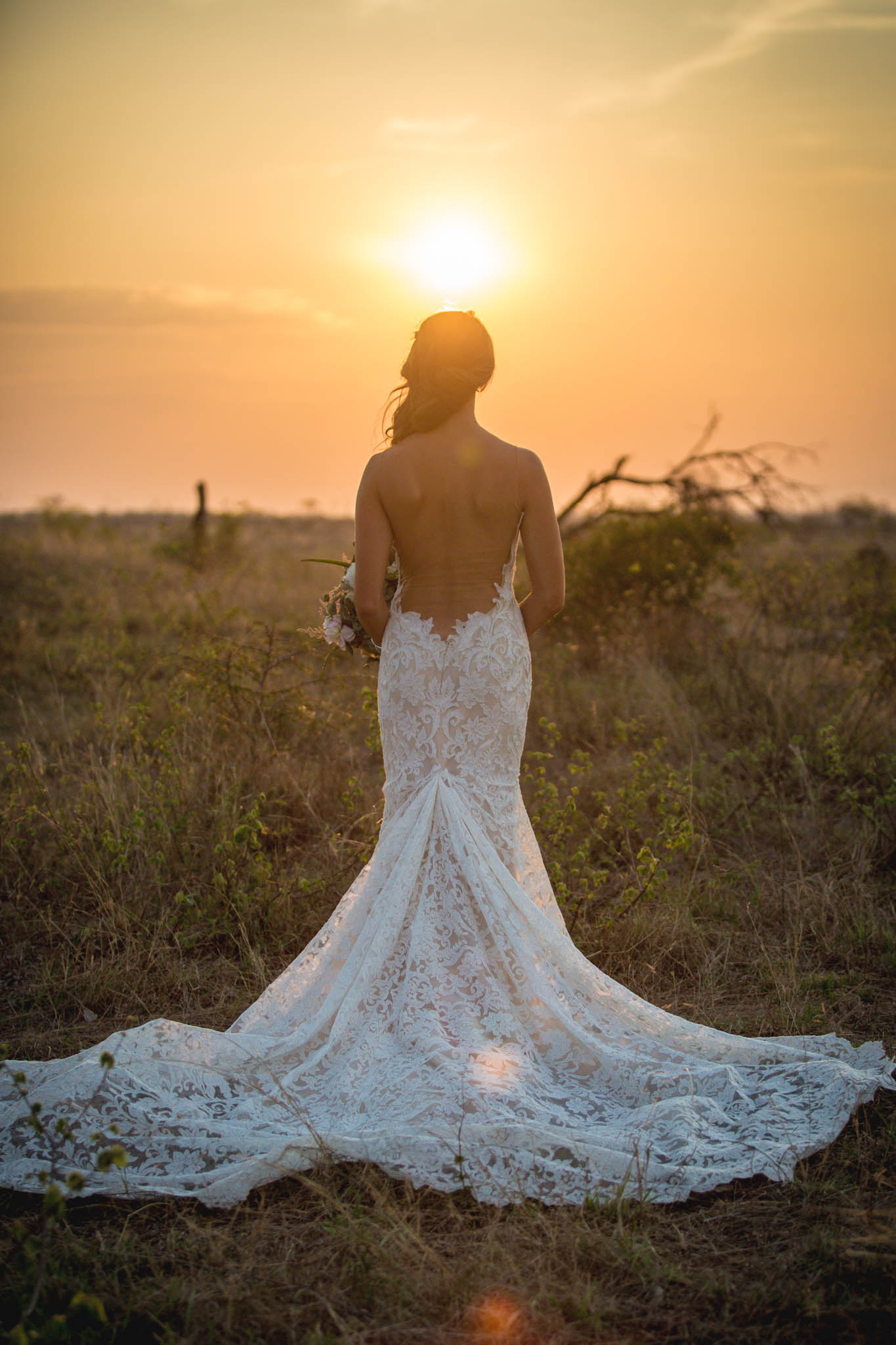 Louise Meyer Photography - a bride looking at a sunset