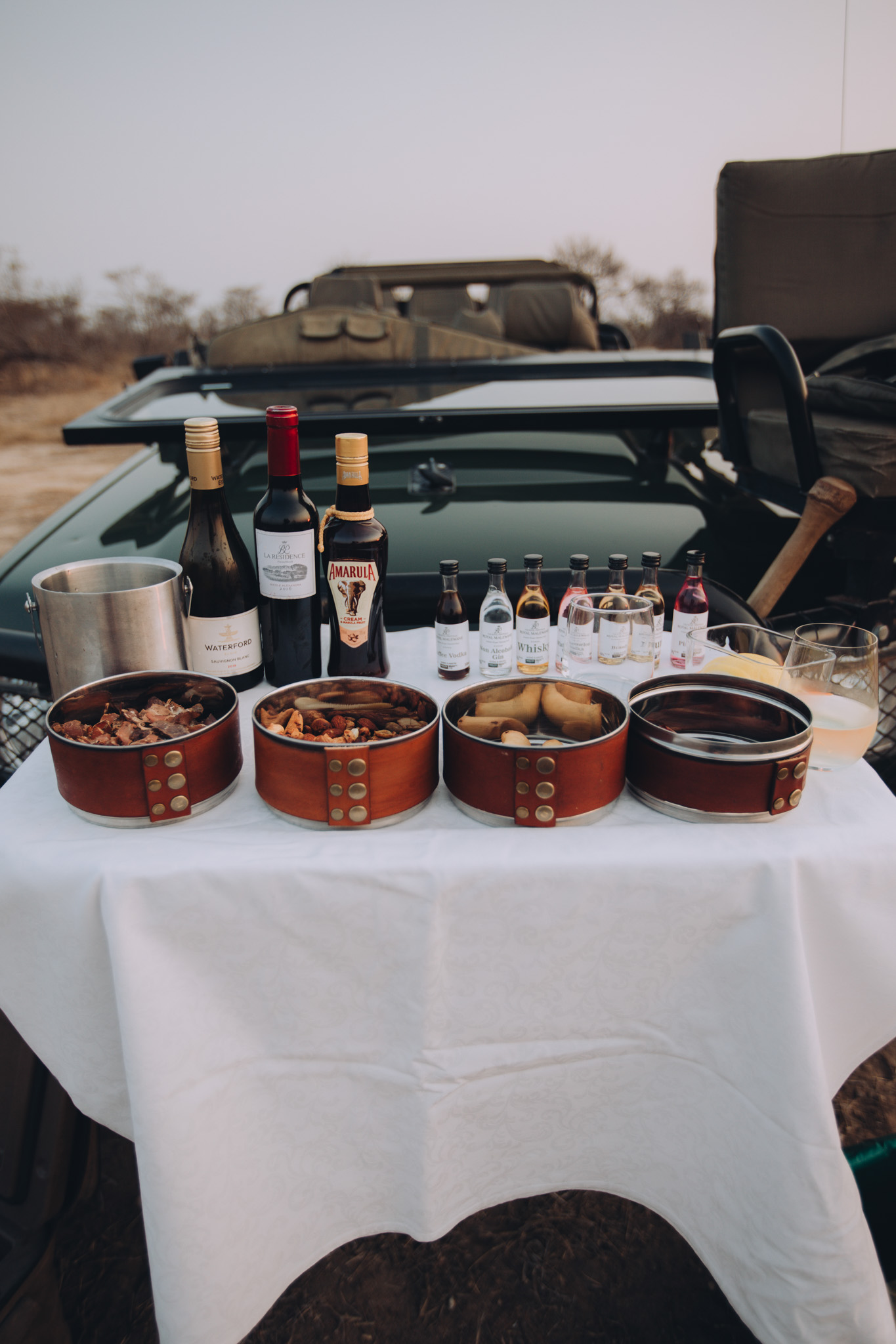 Louise Meyer Photography - food and drinks displayed on a safari vehicle