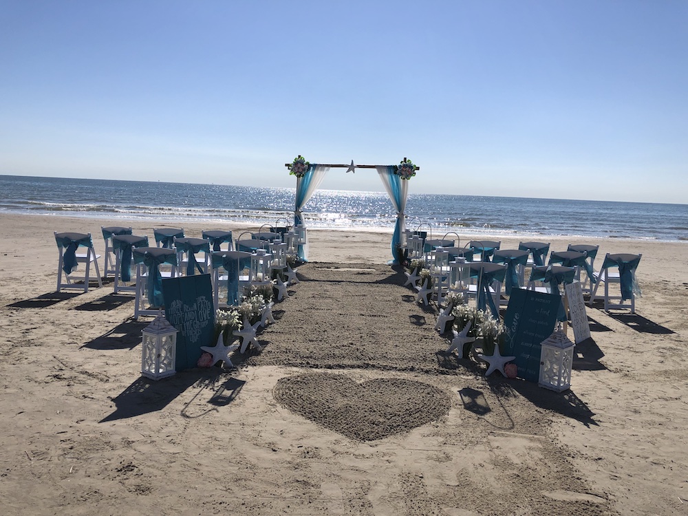 Intimate beach wedding with arch