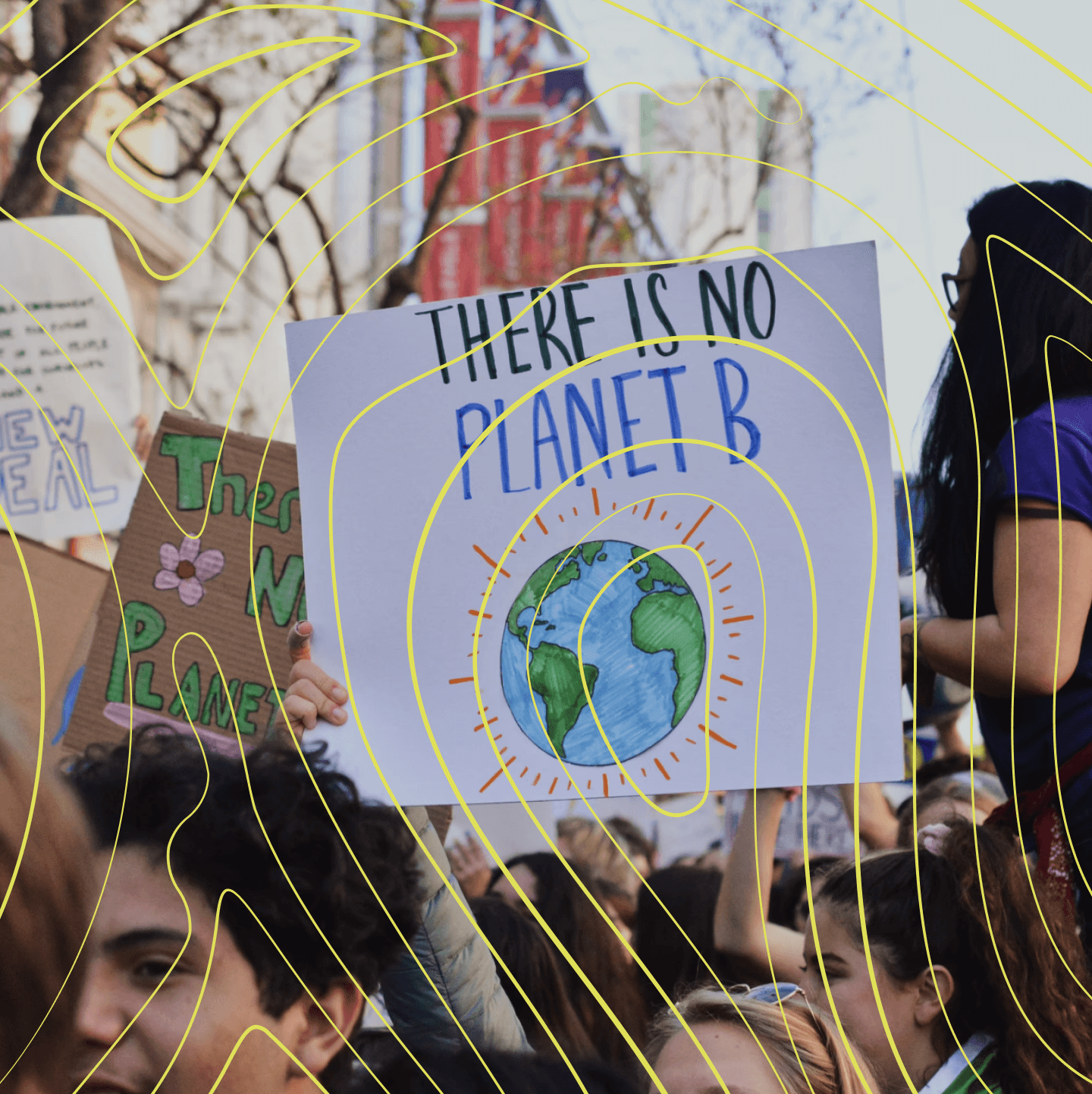 Young person at a climate protest holding up a sign that reads, 'there is no planet B'.
