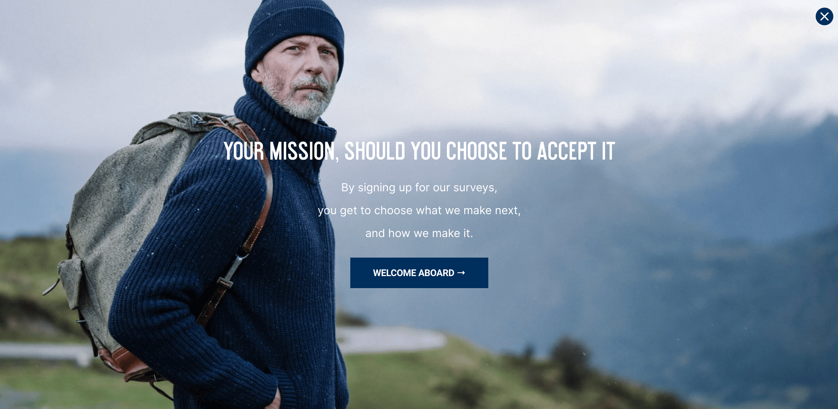 Man wearing a sweater, hat and with a backpack, with mountains in the background and overlaid text: Your mission, should you choose to accept it. By signing up for our surveys, you get to choose what we make next, and how we make it