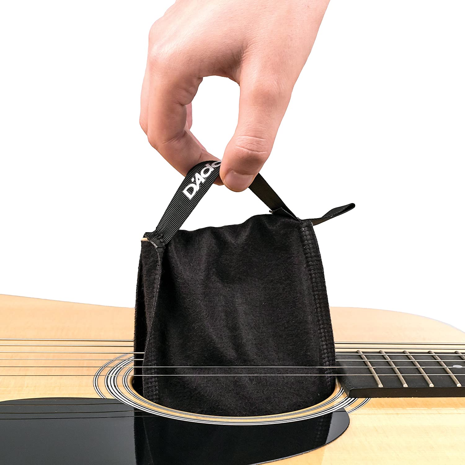 Image of two way humidification system being inserted into the guitar