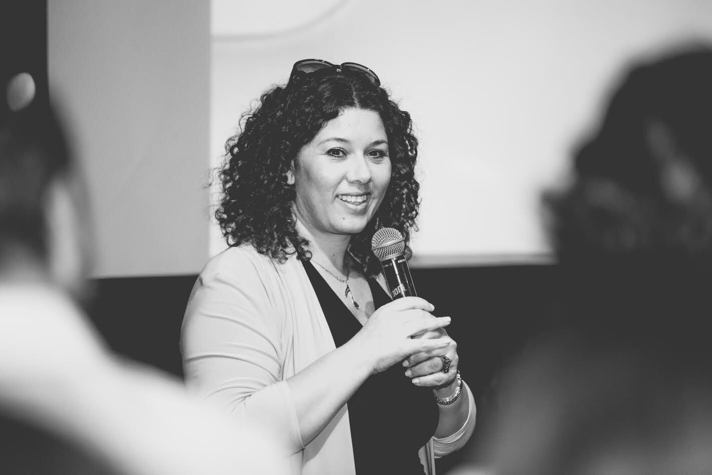 black and white photo of kim ades presenting