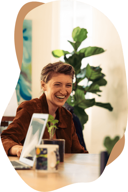 Young woman smiling at the hot desk.
