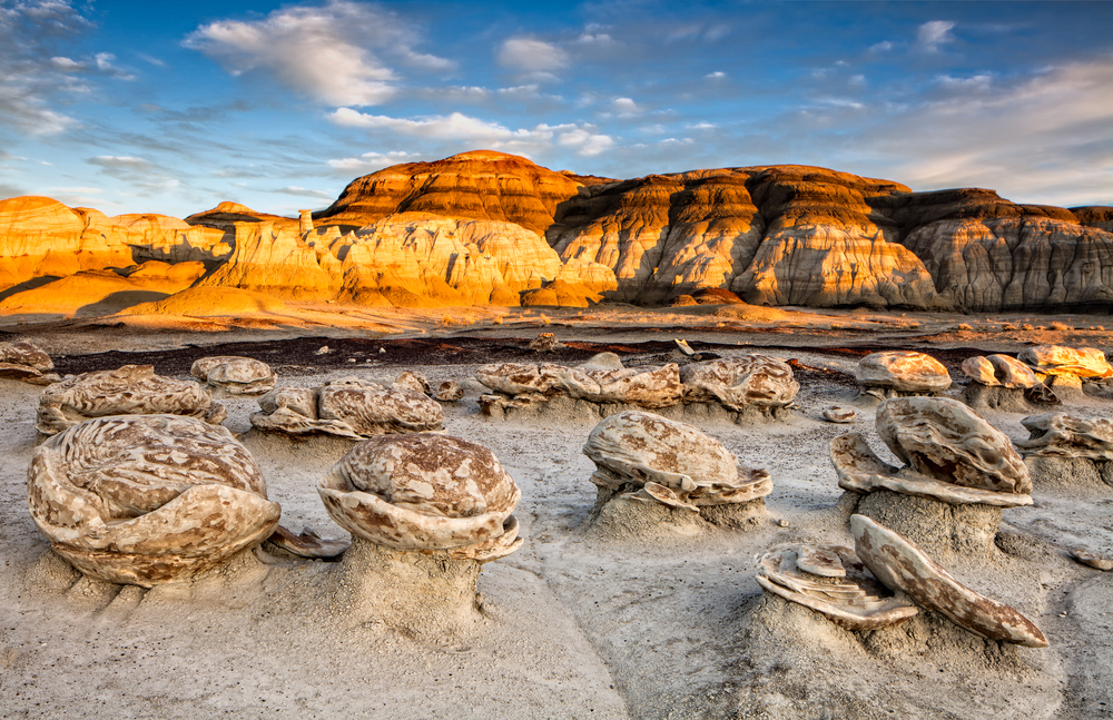 Plateau in background with natural stone structures that resemble tables in foreground