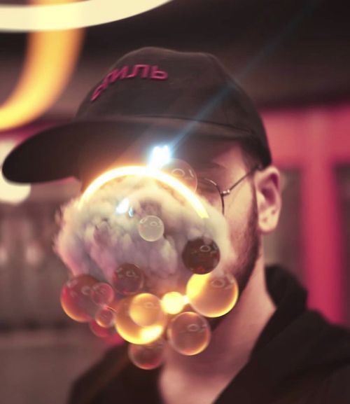 Photo of Alex Gil with a atomic visuals in front 