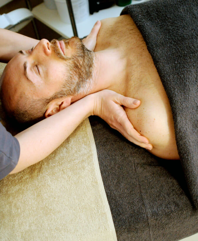 A man enjoying a relaxing should massage.
